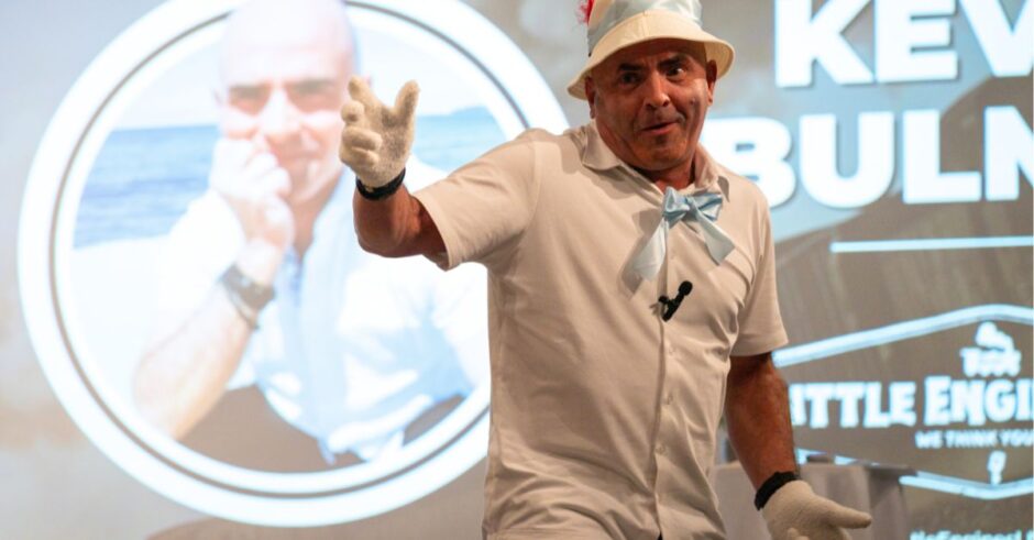 Kevin Bulmer dressed as Pinocchio on stage, teaching about authenticity and the journey to becoming "real."