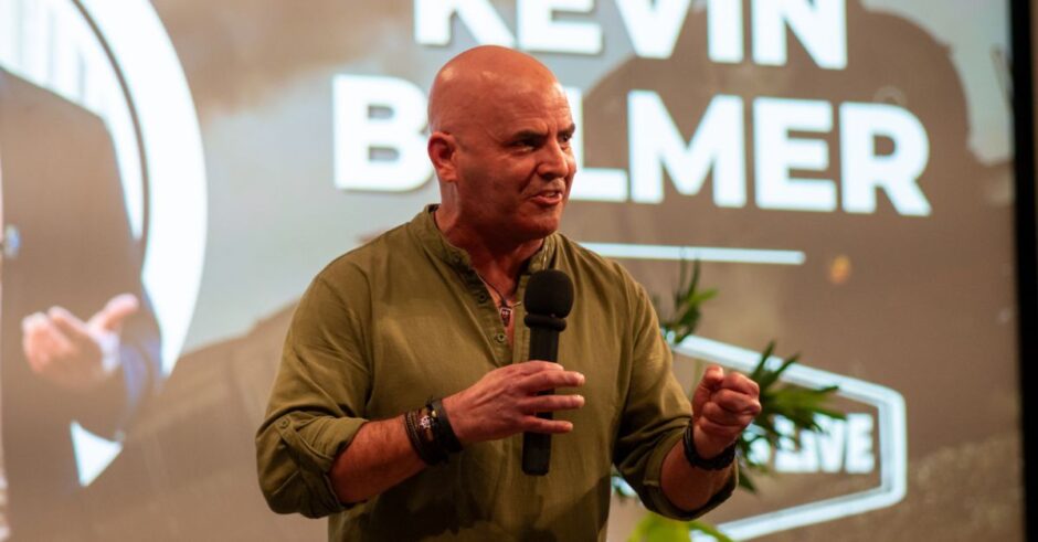 Kevin Bulmer delivering a keynote on brand story and strategy, focusing on leadership values and authenticity.