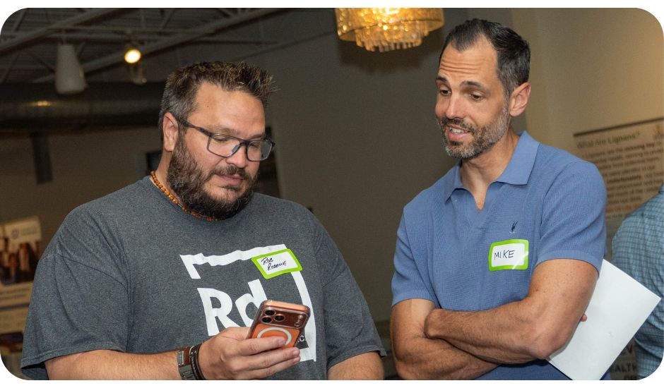 Two members of the Little Engines REAL Success Support Community collaborating and sharing ideas during a live event.