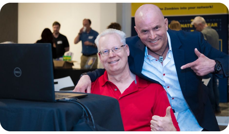 Kevin Bulmer and AV technician Paul smiling and giving a thumbs up at Little Engines LIVE, celebrating alignment and community energy.