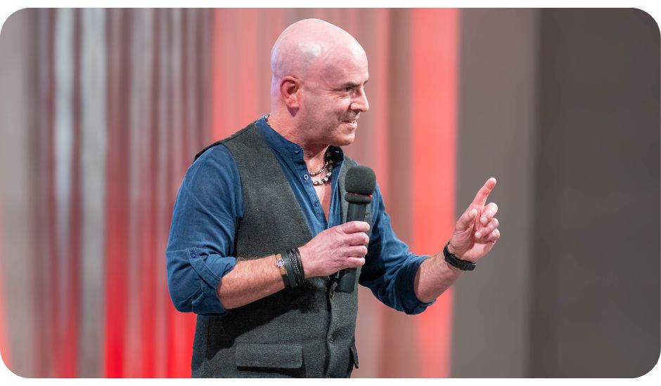 Navigating change speaker Kevin Bulmer presenting on stage.