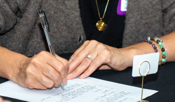 Close-up of a participant’s notebook filled with handwritten insights and pricing strategies from a leadership workshop.